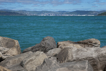 Fototapeta na wymiar Rocks. Eastbourne New Zealand. Wellington Harbour. Coast. Rona Bay wharf.