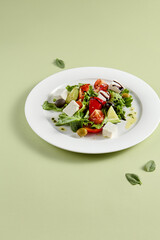 Classic Greek Salad with Feta Cheese and Fresh Vegetables on White Plate