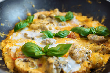 omelet with basil in frying pan, breakfast