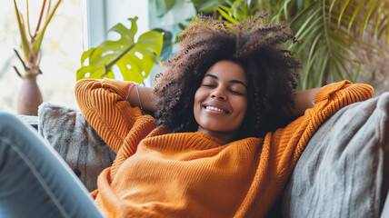Happy afro american woman relaxing on the sofa at home - Smiling girl enjoying day off lying on the couch - Powered by Adobe
