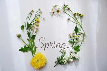 Beautiful green and flowers decoration wreath decoration with Spring lettering. Spring garden...