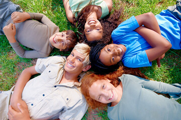 Nature, circle and portrait of children on grass in outdoor park, field or garden together. Happy, diversity and top view of young kids relaxing and laying on lawn in woods or forest for summer.