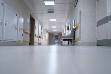 Modern spacious hospital corridor with comfortable couches for patients. Construction of medical...