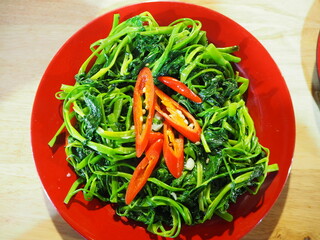 Close up of cooked morning glory - an asian vegetable dish