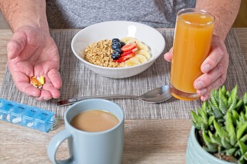 Close up of senior man with tablets in hand ready to have a healthy breakfast