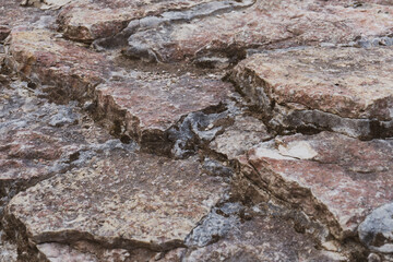 Stone steps in an old fortress as a structural background.