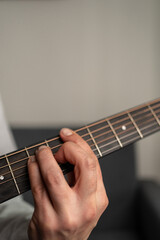 Fototapeta na wymiar A closeup shot of a man's hand playing the guitar 
