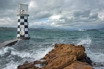 Poster Lighthouse and interislander ferry. at Halswell point. Wellington New Zealand. Bay. Sea. Coast. © A