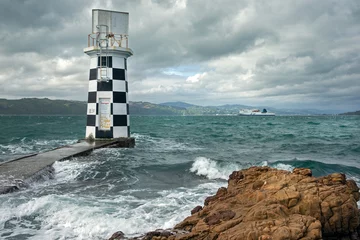 Fotobehang Lighthouse and interislander ferry. at Halswell point. Wellington New Zealand. Bay. Sea. Coast. © A