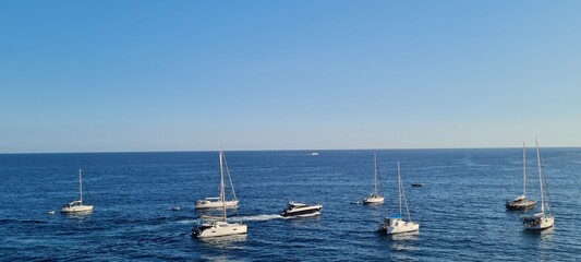 Beautiful seascape with yacht near shore in the sea. Modern sailboat on a sunny summer day. Sailing...