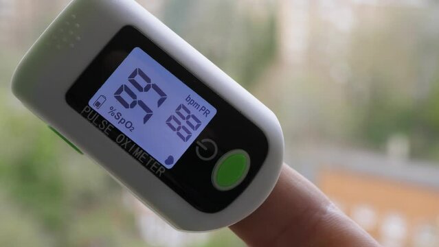 Pulse oximeter.
Close-up of a pulse oximeter measuring heart rate and blood oxygenation level.