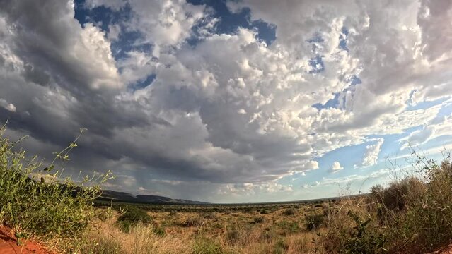 Timelapse that captures the dynamic evolution and graceful dance of rain clouds across the stunning African landscape of the dry Southern Kalahari.
