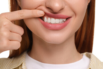 Woman showing her clean teeth on white background, closeup