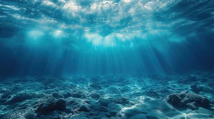 Fotobehang Dark blue water of a deep ocean with sun rays reaching the rocky seabed. Beautiful underwater landscape. © Falk