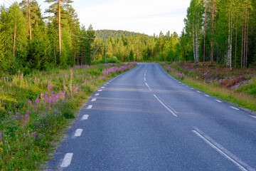 Country road trough a forrest in the north of Sweden.