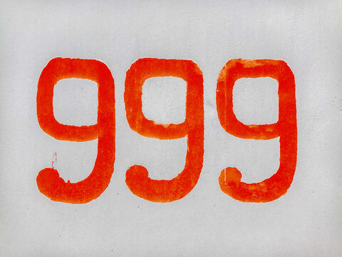 old concrete wall with red number 999