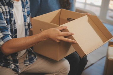 Two Asian blogger showing clothes in front of the camera to recording vlog video live streaming at her shop. Online Shopping Cart notion. on sofa at home