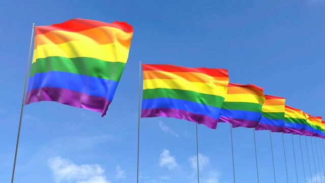 Looping video of Rainbow flag Waving on blue sky background, Loop Animation LGBT Pride flag