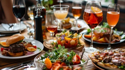 Foto op Canvas "Repas raffiné : Table dressée avec steak, salades, pains et vin rouge" © Estelle