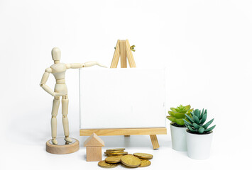 Wooden doll with empty easel on white background; business or creative concept