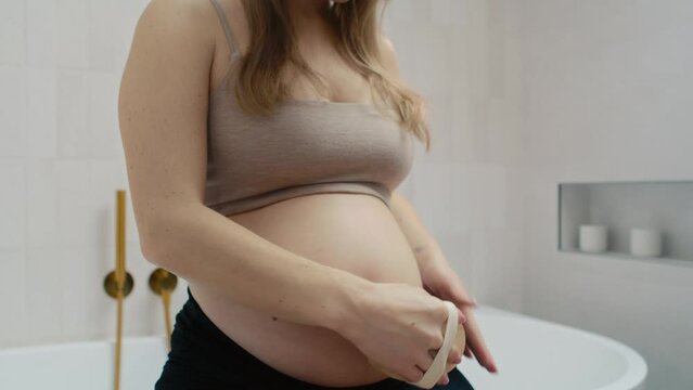 Pregnant woman doing dry body brushing
