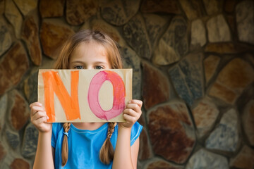 Girl holding a sign saying "No, to abuse, mistreatment, corruption of children, violence".