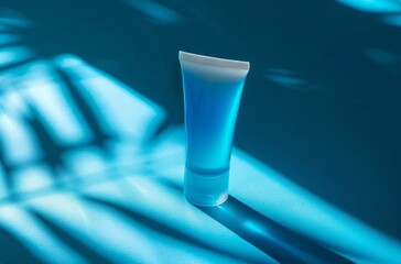 cosmetic tube on a blue surface