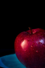 close up red apple on black background