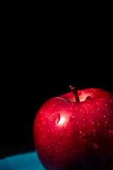 red apple on black background