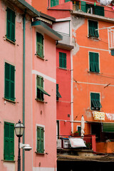 Fototapeta na wymiar Italian houses with green windows in a cute old Italian city in Cinque Terre 
