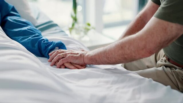 Patient, person and hand holding on hospital bed for empathy or support for health problem, diagnosis or virus. People, fingers and embrace for difficult news or marriage compassion, unity or love