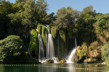 Kravice waterfalls on river Trebizat in summer during sunny day, long exposure with silky water