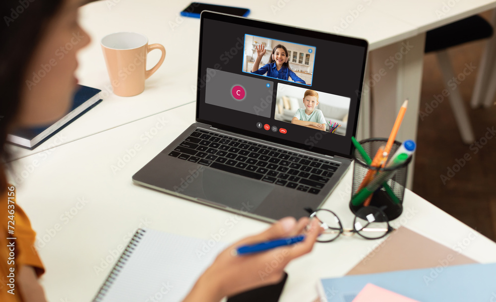 Poster teacher with computer having video conference chat with students