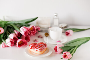 Cappuccino with doughnut heart, bakery, party morning, pink tulips