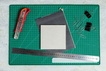 Green cutting table with craft accessories. Craft concept. DIY concept.