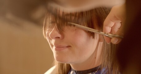 Close-Up young woman portrait during Haircut: Sharp Scissors Trim Hair Strands. Artistry of...