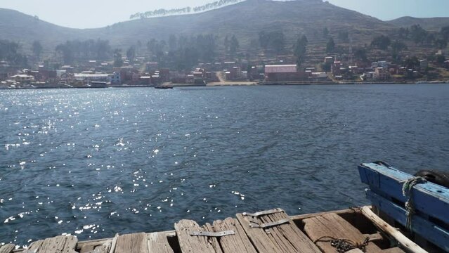 wooden barges transporting cars and buses across the strait of Tiquina at lake Titicaca in the high altitude of the Andes mountains in Peru on the way to La Paz.
