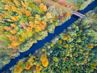 Aerial view of railway bridge over the Masurian Canal in autumn colors, Mazury, Poland