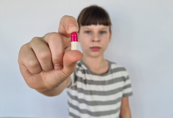Girl child teenager with pills and vitamin supplements to improve immunity