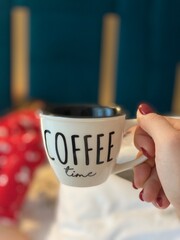 hand holding cup of coffee