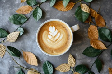Nature themed coffee cup with leaf arrangement in a flat lay position