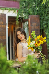 Smiling Woman with Vibrant Sunflower Bouquet