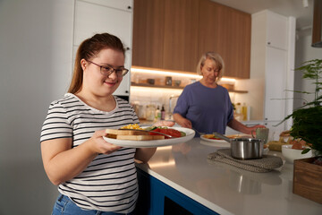 Down syndrome woman serving breakfast