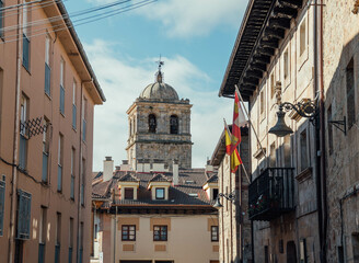Tower of a gothic church against a blue sky. Aguilar de Campoo, Spain