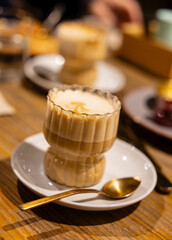 Caramel Latte in a Ribbed Glass Cup, vertical photo.