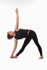 Utthita trikonasana, Ashtanga yoga  Side view of woman wearing sportswear doing Yoga exercise against white background.