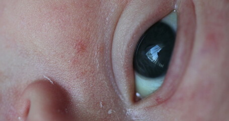 Newborn baby eyes observing and learning about the world, macro close-up of infant eye