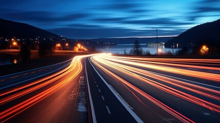 Fototapeta na wymiar Long exposure of a road with light trails of passing vehicles at night