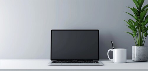 Minimalistic scene with a rectangular form laptop near an empty white mug for simplicity.