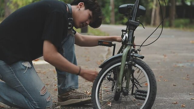 Healthy And Active Lifestyle, Going To Work On Eco Transport. Smiling Attractive Millennial Male Employee In Glasses With Bag And Cup Of Takeaway Coffee, Moving Bike In City Park In Summer, Outdoor